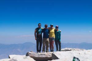 A group of hikers at the summit of Mt Whitney, California
